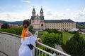 Woman in summer romantic dress at chapel castle travel destination. Summer castle and woman