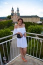 Woman in summer romantic dress at chapel castle travel destination. Summer touristic castle and woman