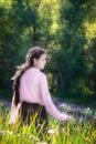 Woman on a summer sunny day walking in field of flowers Royalty Free Stock Photo