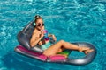 Woman on summer vacation. Girl in swimmsuit. Summertime chick on inflatable mattress.