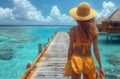 Woman in sun hat and bikini admiring ocean view from dock Royalty Free Stock Photo