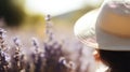 Woman with a sun hat in a lavender field, blurred floral background Royalty Free Stock Photo