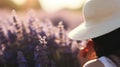 Woman with a sun hat in a lavender field, blurred floral background Royalty Free Stock Photo