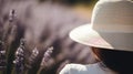 Woman with a sun hat in a lavender field, blurred floral background Royalty Free Stock Photo