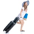 Woman in sun hat, sunglasses and beach bag with suitcase luggage summer smiling happiness looking walking goes running Royalty Free Stock Photo