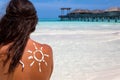 Woman with sun-shaped sun lotion drawing on her back Royalty Free Stock Photo