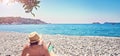 Woman sunbathes tanning beach Zanjic Adriatik sea Montenegro peninsula Lustica
