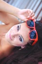 Woman sunbathing in bikini at tropical travel resort. Beautiful young woman lying on sun lounger near pool. Royalty Free Stock Photo