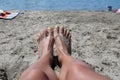 Sandy Serenity: Close-Up of Yellow Pedicured Feet Relaxing in Beach Sand Royalty Free Stock Photo