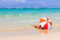 Woman sunbathing with orange umbrellas