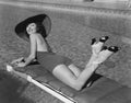 Woman sunbathing at pool Royalty Free Stock Photo