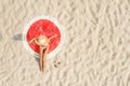 Woman sunbathing on round beach towel at sandy coast, aerial view. Space for text Royalty Free Stock Photo