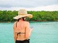 Woman with sunburned back using mobile phone Royalty Free Stock Photo