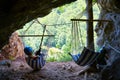 Woman at Suncuius via ferrata, resting in a hammock located in a small cave on the route, with beautiful views of Crisul Repede.