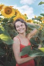Woman in Sunflower Field: Happy girl in a straw hat posing in a vast field of sunflowers at sunset, enjoy taking picture Royalty Free Stock Photo