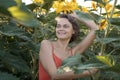 Woman in Sunflower Field: Happy girl in a straw hat posing in a vast field of sunflowers at sunset, enjoy taking picture Royalty Free Stock Photo