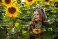 Woman in a sunflower field. Sunny day. Royalty Free Stock Photo
