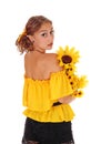 Woman with sunflowers looking over shoulder. Royalty Free Stock Photo