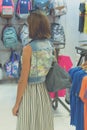 Woman in sunglasses with fashion snakeskin python bag walking in the shopping mall. Bali island, Indonesia. Royalty Free Stock Photo