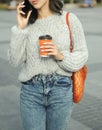 Portrait of a woman in sunglasses holding a string bag and paper cup of coffee Royalty Free Stock Photo