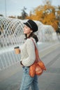 Portrait of a woman in sunglasses holding a string bag and paper cup of coffee Royalty Free Stock Photo