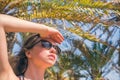 Woman in sunglasses looking on the sky in the palm trees forest. Seychelles islands. Royalty Free Stock Photo