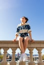 Woman with sunglasses making a bubble with chewing gum posing in the city Royalty Free Stock Photo