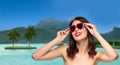 Woman with sunglasses over bora bora beach