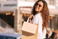 Woman, sunglasses and shopping bag in city or gift discount or retail sale, product or promotion. Female person, travel Royalty Free Stock Photo