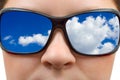 Woman in sunglasses and sky reflection Royalty Free Stock Photo