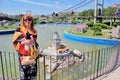 Woman in sunglasses standing near the small Maidens Tower and Bosphorus bridge on the background