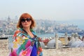 Woman in sunglasses standing near the Suleymaniye mosque with Galata Tower background