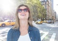 Woman with sunglasses on street with flare against city background Royalty Free Stock Photo