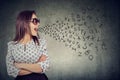 Woman in sunglasses talking with alphabet letters coming out of her mouth. Royalty Free Stock Photo