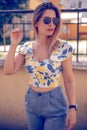 woman with sunglasses wearing trendy summer clothes outside Royalty Free Stock Photo