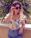 woman with sunglasses wearing trendy summer clothes outside Royalty Free Stock Photo