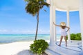 Woman in a sunhat enjoying a scenic Caribbean beach resort while on vacation. Royalty Free Stock Photo