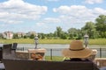 Woman in a sunhat sitting on a patio bench Royalty Free Stock Photo