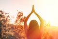 Woman at sunset doing yoga in the summer forest. The concept of fitness, yoga and sports. Back view. Close up. Sunset light