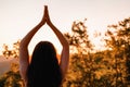 Woman at sunset doing yoga in the summer forest. The concept of fitness, yoga and sports. Back view. Close up Royalty Free Stock Photo