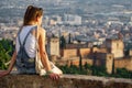 Woman at sunset over Granada and Alhambra