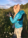 Woman at sunset photographs a grass on the fringe of the forest Royalty Free Stock Photo