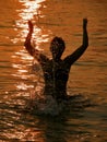 Woman at sunset in sea Royalty Free Stock Photo