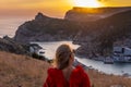 Woman sunset sea mountains. Happy woman siting with her back on the sunset in nature summer posing with mountains on Royalty Free Stock Photo