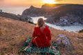 Woman sunset sea mountains. Happy woman siting with her back on the sunset in nature summer posing with mountains on Royalty Free Stock Photo