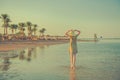 Woman at sunset seashore