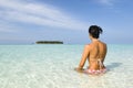 Woman suntanning on white sand beach