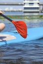 Woman on SUP board and drops fall from the paddle. Royalty Free Stock Photo