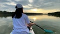 woman on supboard at sunset