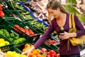 Woman in supermarket buying groceries